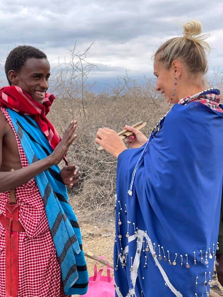 Tourist interacting with Maasai guide in traditional attire